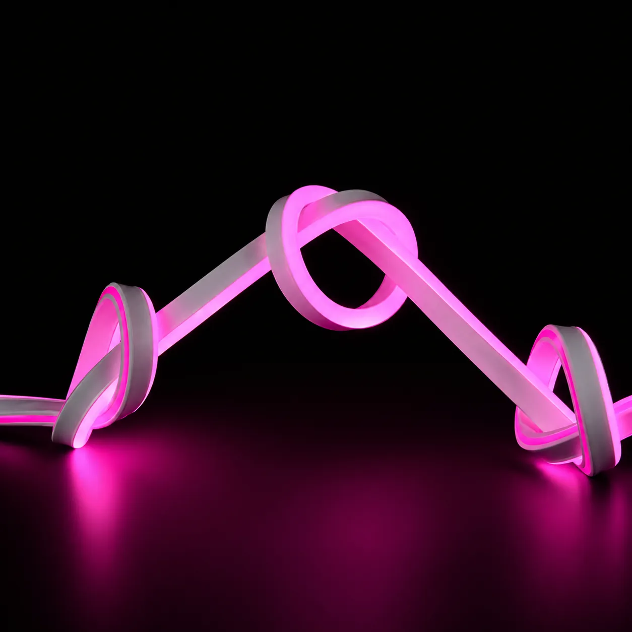 8x16mm pink LED neon flex light sample bent into knots on a dark background